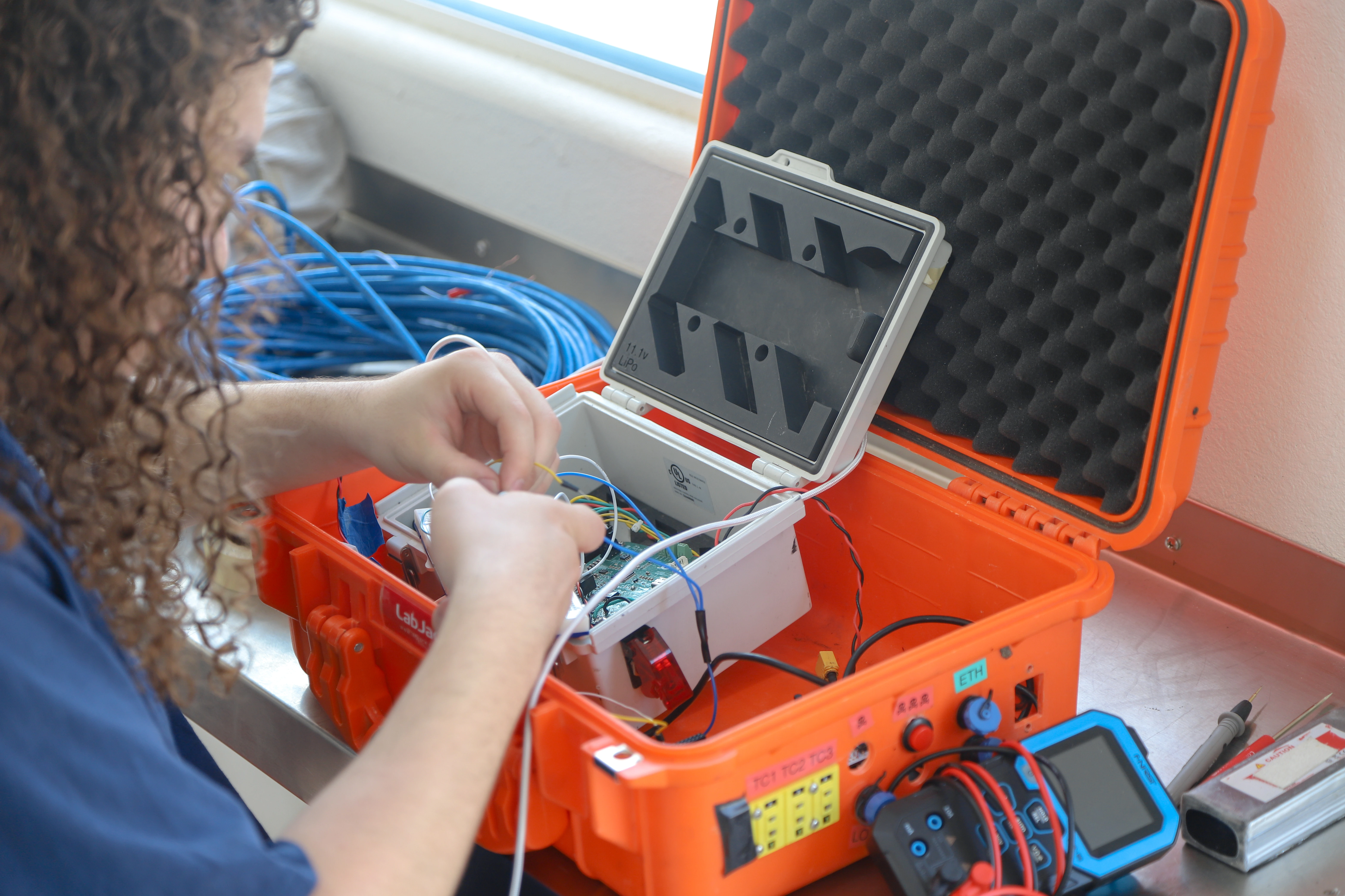 Wiring and electronics inside an orange equipment case